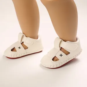 Detailed view of cream baby walking sandals with soft soles and velcro strap