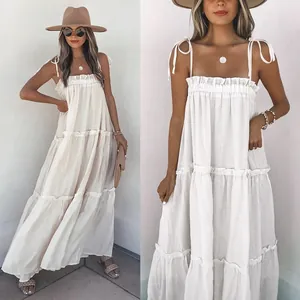 Elegant white tiered maxi dress featuring tie-shoulder straps and delicate ruffle neckline detail