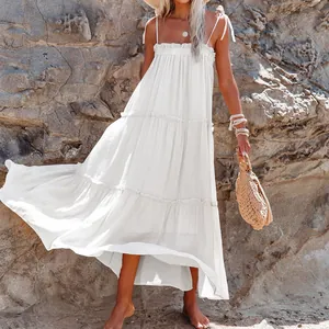Full-length view of a flowy white tiered sleeveless maxi dress for beach vacations.