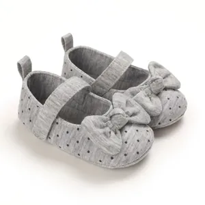 Soft-sole baby girl walking shoes in grey with polka dots and a large bow