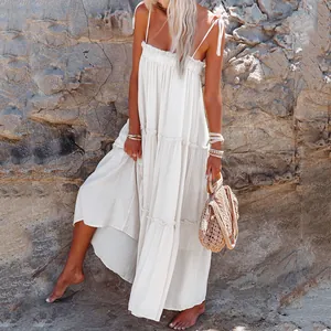 Detailed view of a white tiered strap maxi dress with ruffled edges and breezy fabric texture