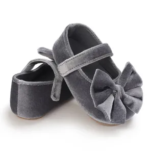 Detailed view of grey velvet baby girl princess shoes featuring a large decorative bow