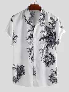 Detailed view of men's short-sleeve shirt featuring black floral ink painting on white fabric