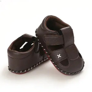 Detail view of brown baby walking sandals with soft anti-slip soles and velcro straps.
