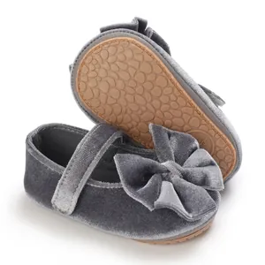 Detailed view of grey velvet baby girl walker shoes with large bow and anti-slip sole