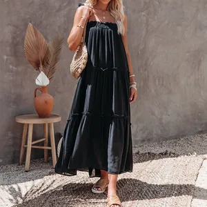 Detailed view of stylish black tiered maxi sun dress with pleated chest and thin straps.