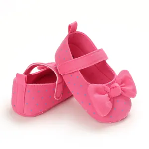 Macro view of textile texture and stitching on pink polka dot baby girl princess shoes