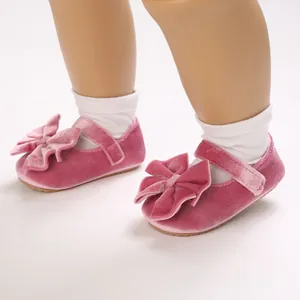 Detail view of pink velvet baby princess shoes with soft bow and velcro strap
