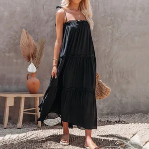 Elegant side view detail of a black tiered maxi dress with thin spaghetti straps