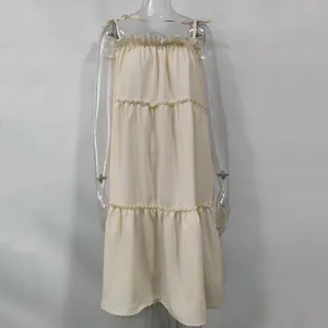 Front view of a cream tiered ruffled sleeveless sundress displayed on a clear mannequin