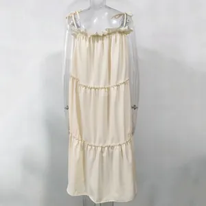 Front view of cream-colored tiered strap dress with ruffle detail on mannequin