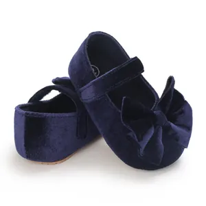 Detailed view of navy blue velvet baby girl Mary Jane shoes with a large bow detail