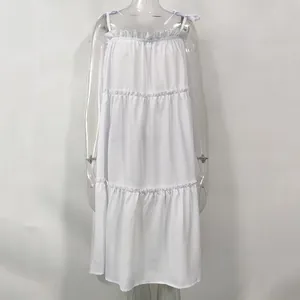 Full front view of a white tiered spaghetti strap summer dress on a transparent mannequin