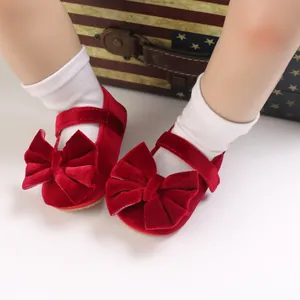 Detailed view of soft sole red velvet baby princess shoes with a large cute bow