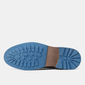 Detailed macro view of the durable blue non-slip rubber lug sole for men's dress shoes