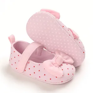 Detailed view of pink polka dot baby girl princess shoes with soft soles for pre-walking.
