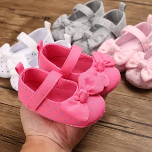 Detail view of colorful baby girl princess walker shoes with bow and polka dots