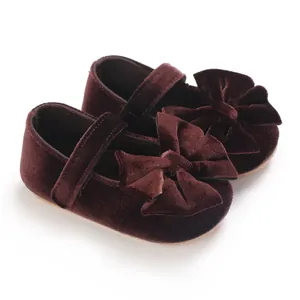 Detailed view of burgundy velvet baby girl princess shoes with a large bow