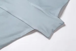 Gros plan montrant la texture du tissu bleu clair et les détails des coutures de qualité