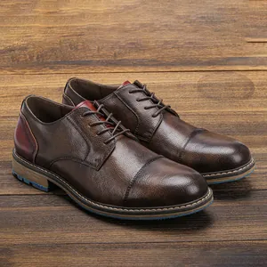 Detail view of stylish men's brown distressed leather business casual shoes on wood