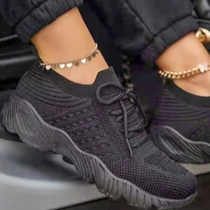 Detailed side view of comfortable and breathable black fly-knit sneakers for women.