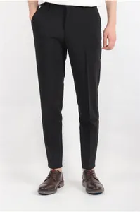 Classic brown business dress shoes for men paired with formal black trousers in a studio shot