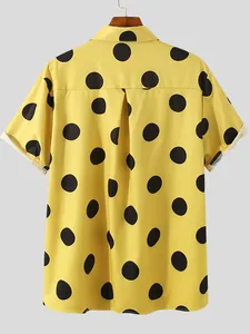 Detailed back view of yellow short-sleeved Hawaiian shirt with large black dots