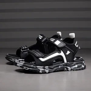 Close-up of black breathable boys sports sandals with camouflage non-slip sole.