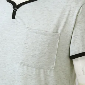 Close-up of grey heather men's sleep shirt with pocket and black contrast trim.