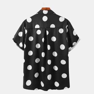 Back view of a black men's short sleeve Hawaiian shirt with large white polka dots