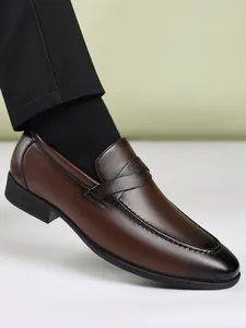 Side view of brown leather loafer showing fine stitching and polished finish