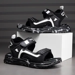 Side view of breathable boys black sports sandals with white accents and camo sole