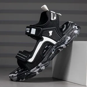 Side view of black breathable kids sports sandal featuring camouflage sole and Velcro straps