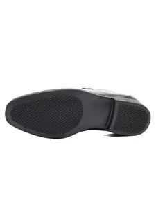 Detailed view of the non-slip rubber outsole and heel of a black leather loafer shoe