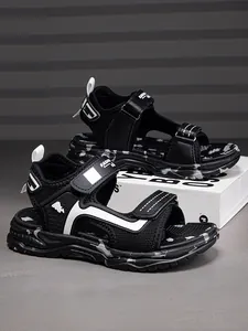Close-up of black and white breathable non-slip beach sandals for boys with velcro straps