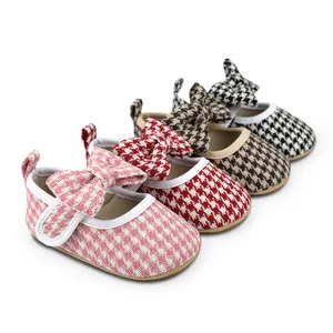 Detail view of four colors of houndstooth baby girl walking shoes with decorative bows