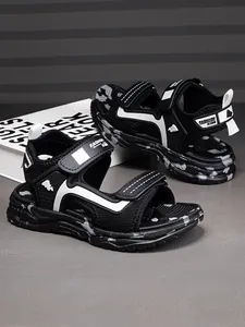 Detailed side view of breathable black and white boys sporty beach sandals with velcro
