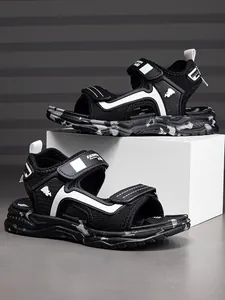 Breathable boys sports sandals with non-slip camouflage sole on a white display stand