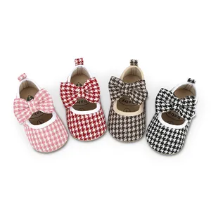 Four pairs of baby girl walker shoes with houndstooth pattern and bows in various colors.