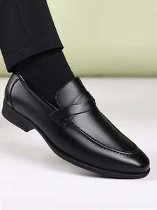 Close-up of black leather loafer showing elegant stitching and premium leather texture