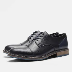 Detailed side view of men's navy blue leather dress shoes with classic cap toe detail