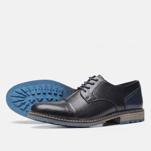 Side profile and sole detail of men's business casual black leather dress shoes
