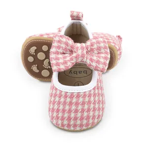 Detailed view of pink plaid baby girl walking shoes featuring a large stylish bowknot