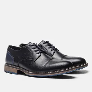 Side view detail of black leather business casual shoes with blue stitching