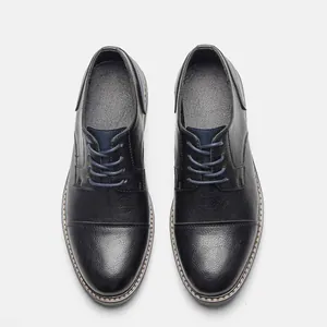 Top view detail of premium black business leather dress shoes featuring blue laces
