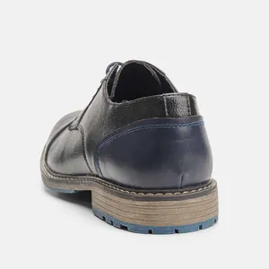 Close-up rear view of men's business casual leather shoe with blue sole detail
