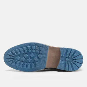 Detailed view of the blue non-slip rubber sole on professional men's dress shoes.