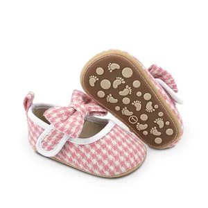 Pink checkered baby girl Mary Jane walking shoes with bow and non-slip sole detail