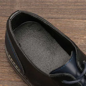 Detail view showing premium leather texture and stitching on men's business casual shoe
