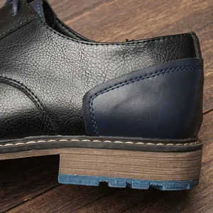 Close-up detail of a men's leather shoe showing contrast stitching and heel texture